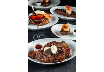 STK - image of a steak dinner with a drink