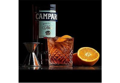 STK - Bottle of Campari with a cocktail and orange